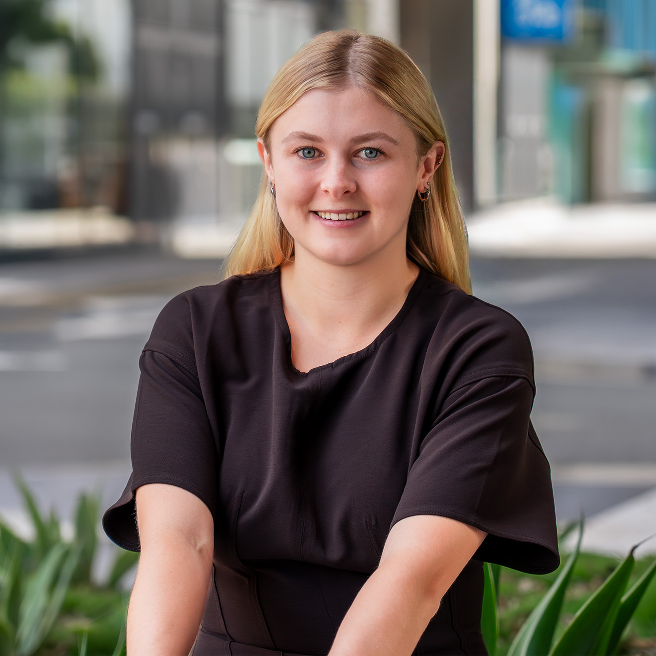 Haylee – Portrait – 2000 x 2000 Maroochydore CBD outside of Axia Litigation Lawyers office sits Paralegal Haylee Spedding